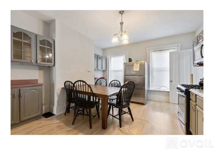 A kitchen with a table and chairs in the middle of the room.