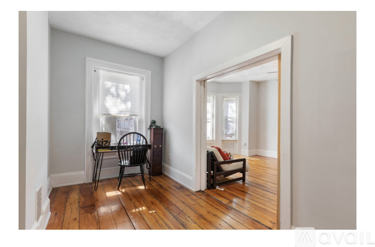 A room with a wooden floor and a chair.