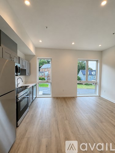 A kitchen with a refrigerator, oven, and sink.