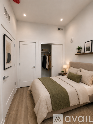 A bedroom with a bed, a coat rack, and a lamp.