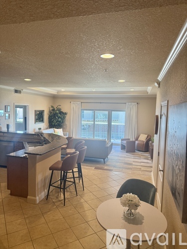 A kitchen area with a table and chairs.