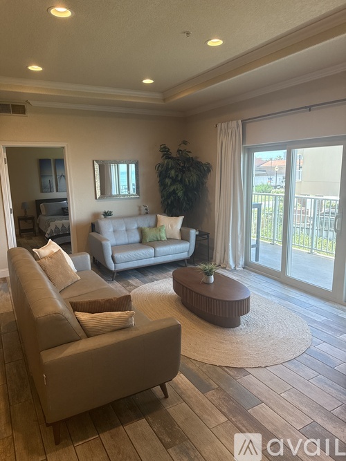 A living room with a grey couch and a coffee table.