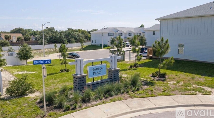 A sign for Harbor Place is in front of a building.