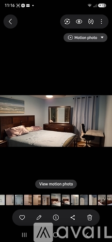 A bedroom with a bed, nightstand, and mirror.