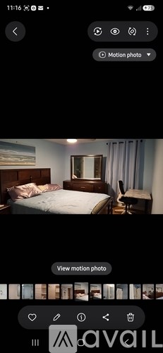A bedroom with a bed, nightstand, and mirror.
