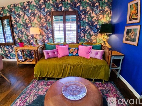 A living room with a green sofa and a wooden coffee table.