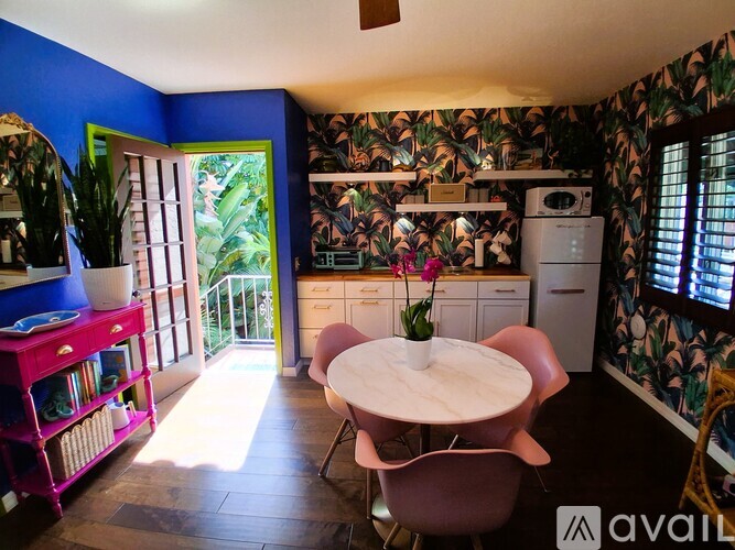 A kitchen with a table and chairs in the middle of the room.