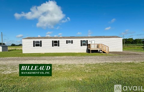 A white building with the words Billeaud Management Co., Inc. on the side is shown in the image.