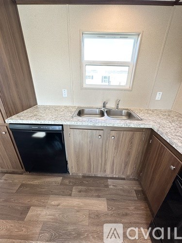 A kitchen with a sink and a dishwasher.