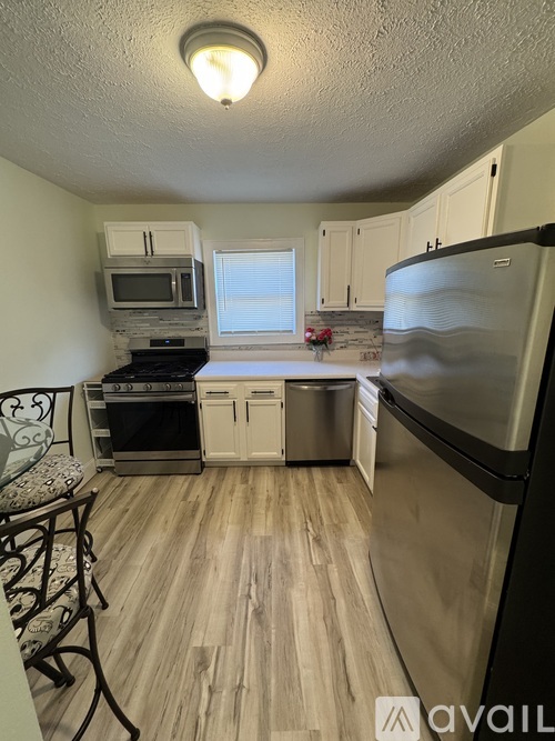 A kitchen with a stove, oven, and refrigerator.