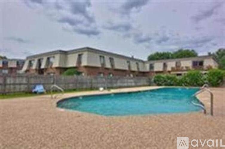 A swimming pool in a backyard with a house in the background.