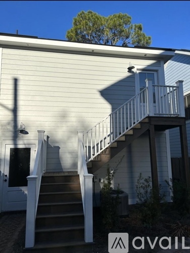A house with a staircase leading to a balcony.
