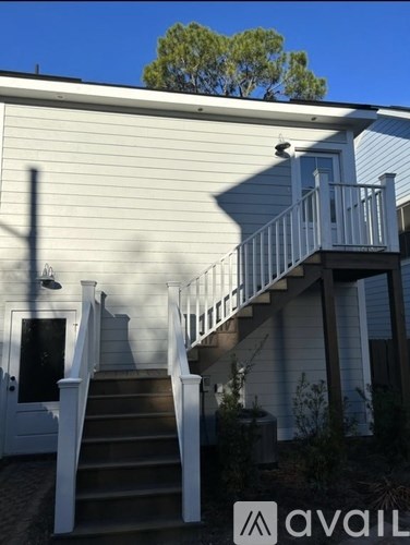 A house with a staircase leading to a balcony.