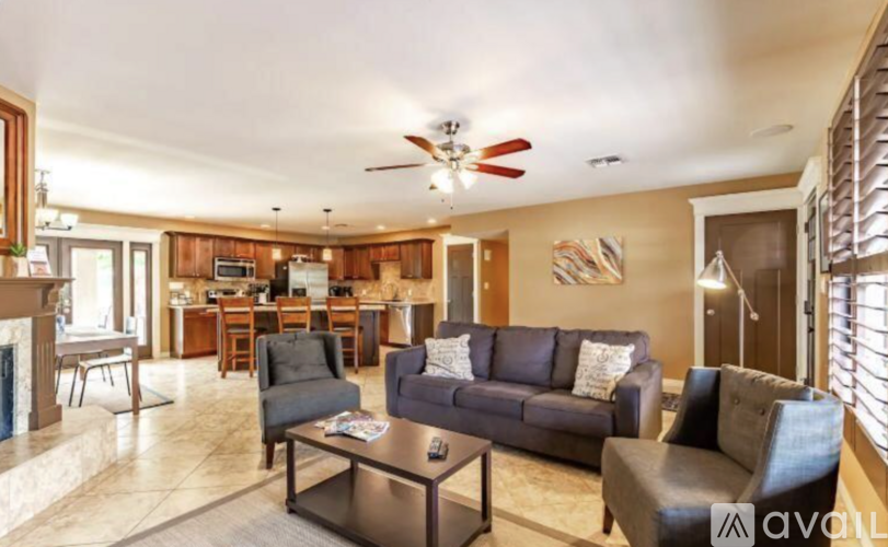 A living room with a grey couch and a coffee table.