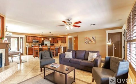 A living room with a grey couch and a coffee table.