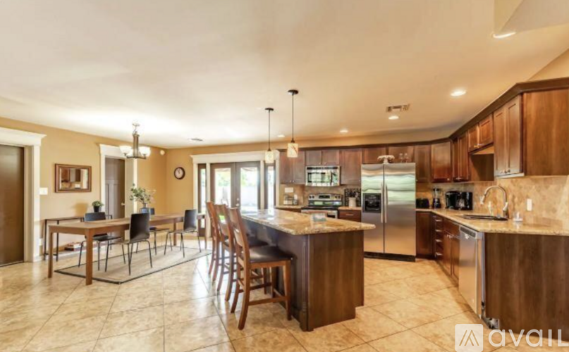 A kitchen with wooden cabinets and a center island.