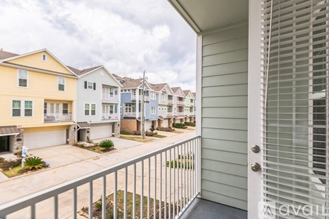 A view of a residential area with houses and a fence.