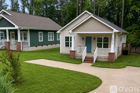 A house with a green and white exterior is available for purchase.