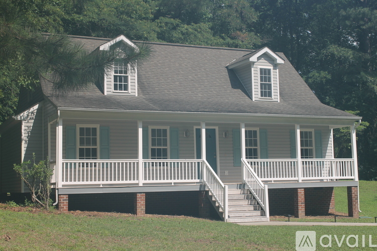 A house with a porch and a balcony is available for sale.