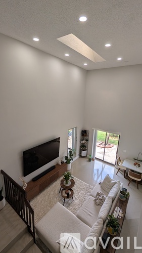 A living room with a television and a staircase.