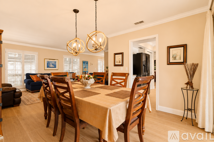 A dining room with a table set for a meal.
