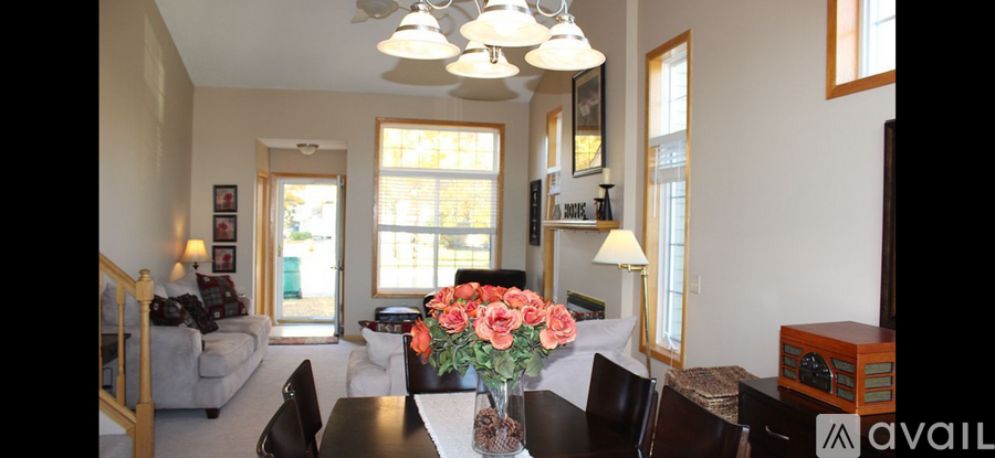 A living room with a dining table and chairs.
