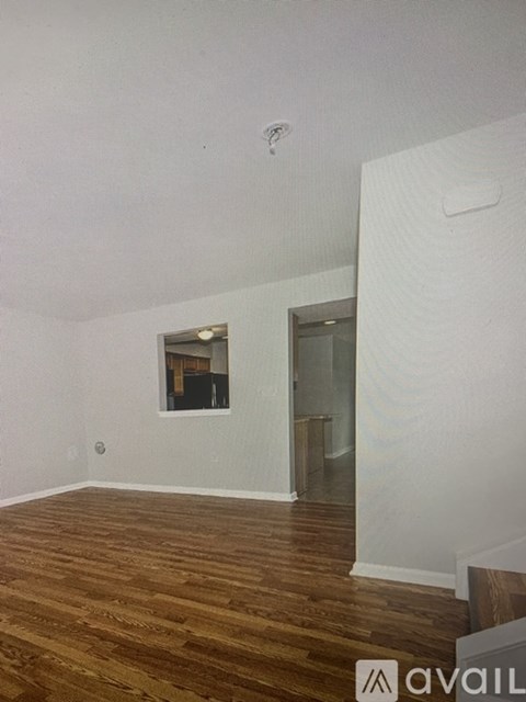 A room with wooden floors and a window.