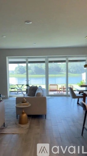 A living room with a couch and a table with a vase on it.