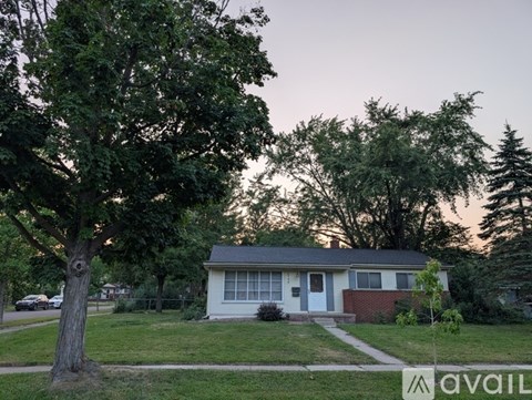 A house with a tree in front of it is for sale.