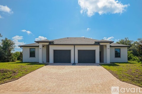 A modern house with a driveway in front of it.