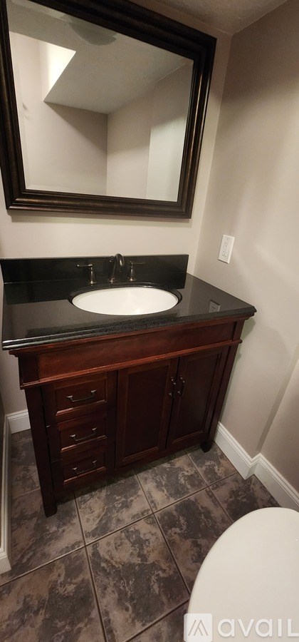 A bathroom with a sink and a mirror.