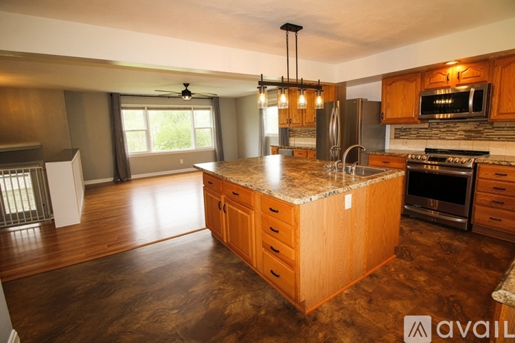 A kitchen with wooden cabinets and a granite countertop.