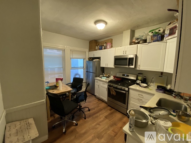 A kitchen with a table and chairs in it.