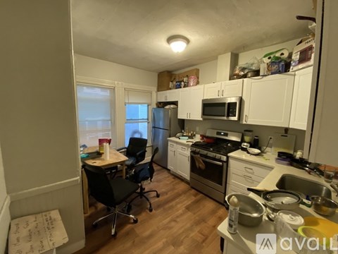 A kitchen with a table and chairs in it.