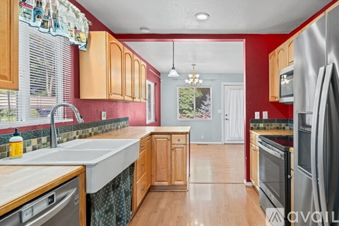 A kitchen with wooden cabinets and a white sink.