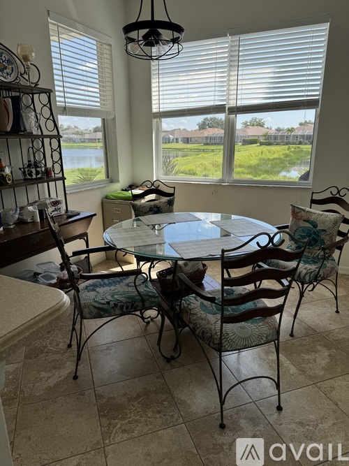 A dining room with a table and chairs.