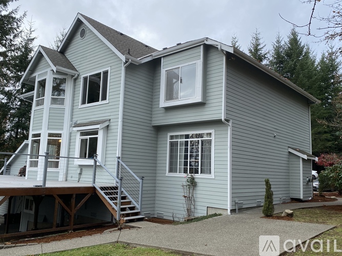 A house with a grey exterior and a deck.