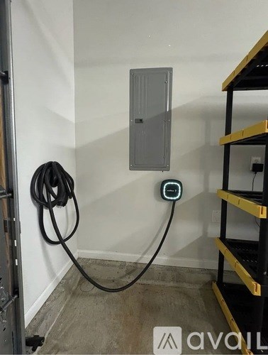 A wall-mounted electrical box is attached to a white wall.