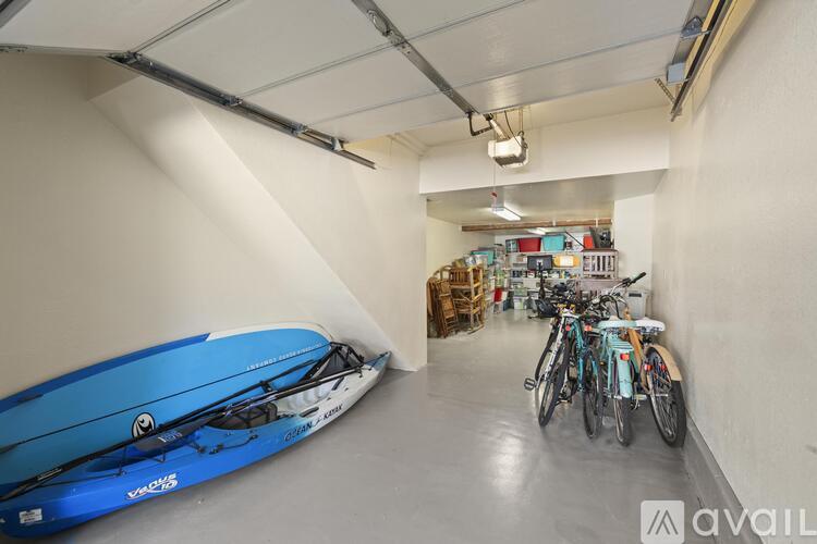 A blue kayak is on display in a spacious garage.