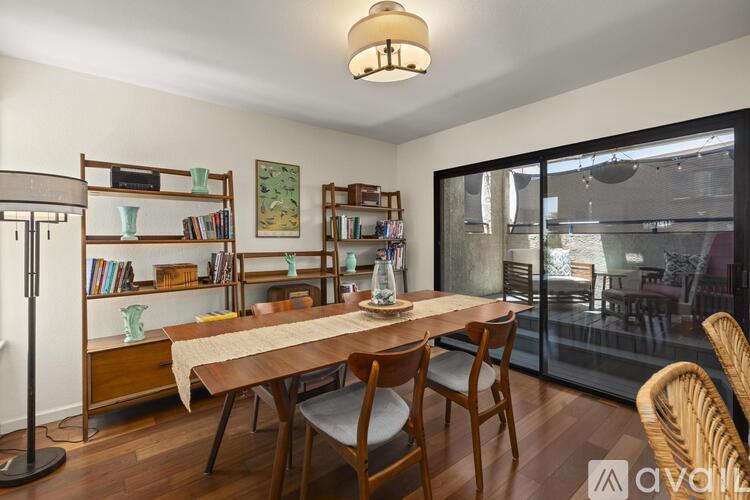 A dining room with a wooden table and chairs.