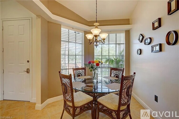 A dining room with a glass table and chairs.