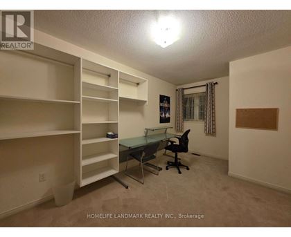 A room with a desk and chairs in it.