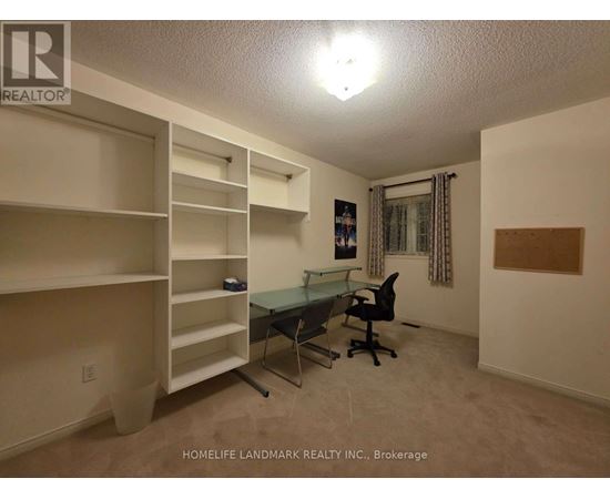 A room with a desk and chairs in it.