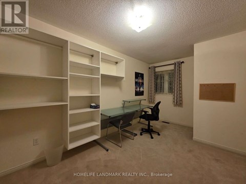 A room with a desk and chairs in it.