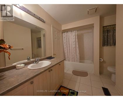 A bathroom with a sink, mirror, and shower.
