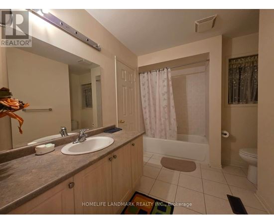 A bathroom with a sink, mirror, and shower.