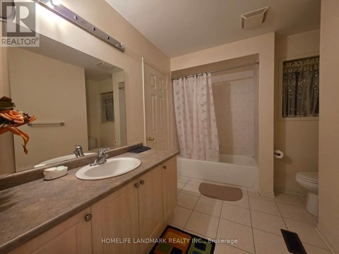 A bathroom with a sink, mirror, and shower.