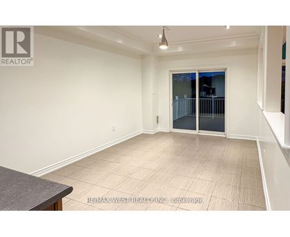 A spacious room with a sliding glass door and a tiled floor.
