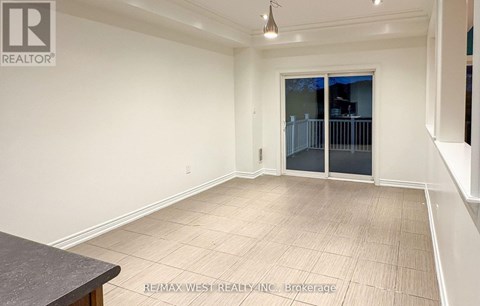 A spacious room with a sliding glass door and a tiled floor.