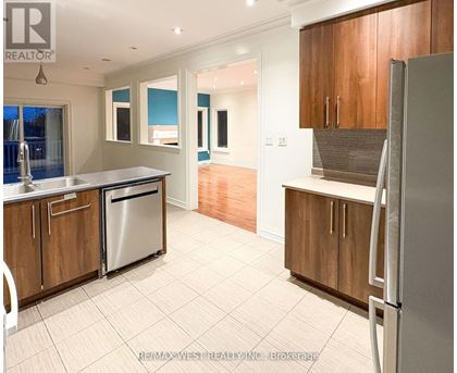 A kitchen with wooden cabinets and a refrigerator.